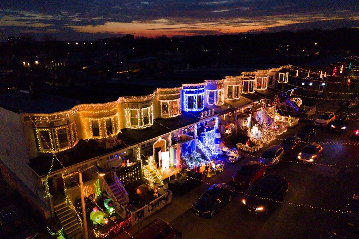 Row homes are seen covered in holiday decorations along the Miracle on 34th Street Hampden Chri ...