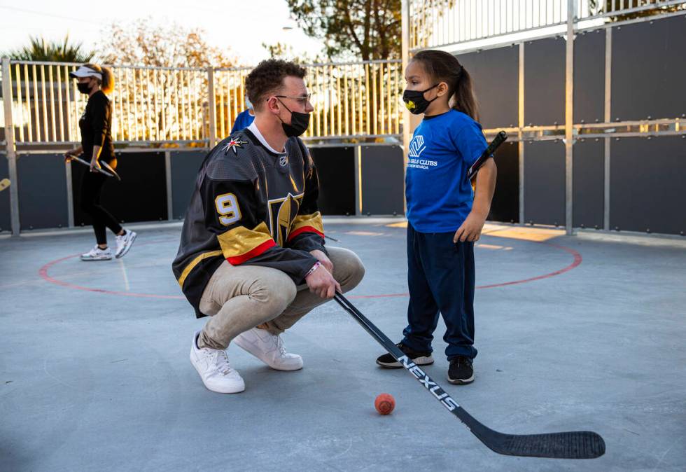 Newly acquired Golden Knights center Jack Eichel, left, talks with David, 8, during a youth hoc ...