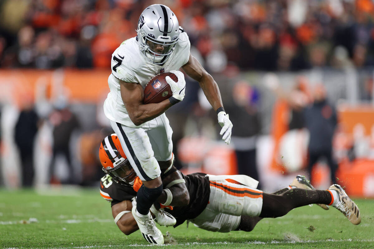 Raiders wide receiver Zay Jones (7) is tackled by Cleveland Browns safety Jovante Moffatt (35) ...