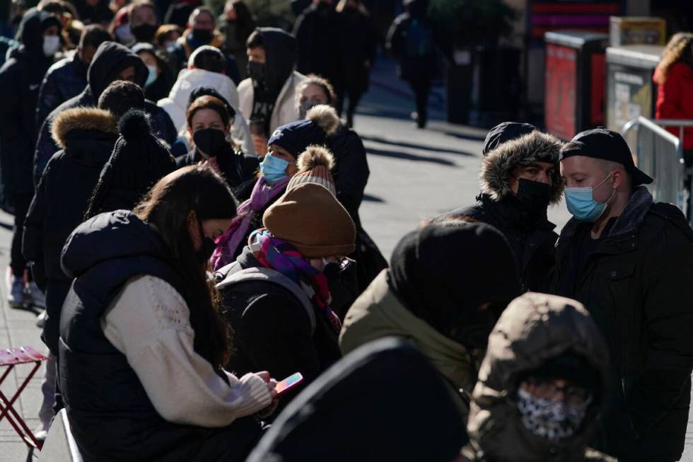 People wait in a long line to get tested for COVID-19 in Times Square, New York, Monday, Dec. 2 ...