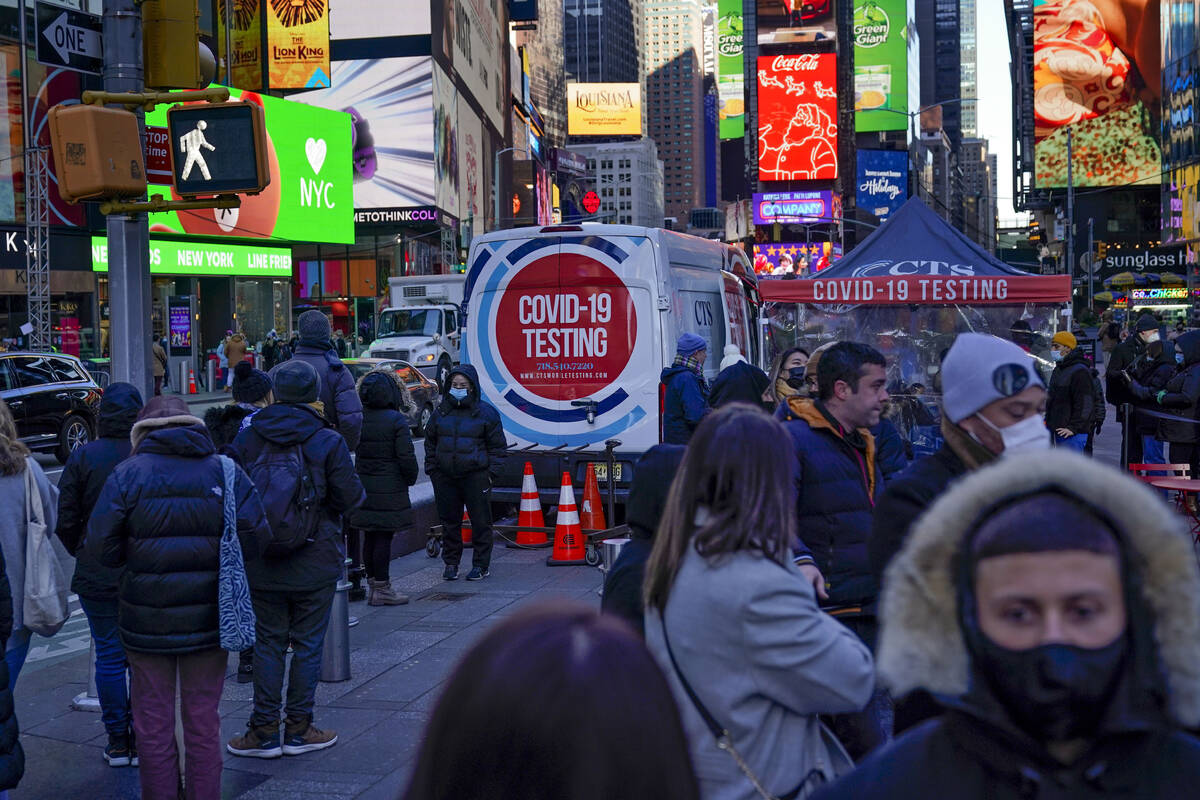 People wait in a long line to get tested for COVID-19 in Times Square, New York, Monday, Dec. 2 ...