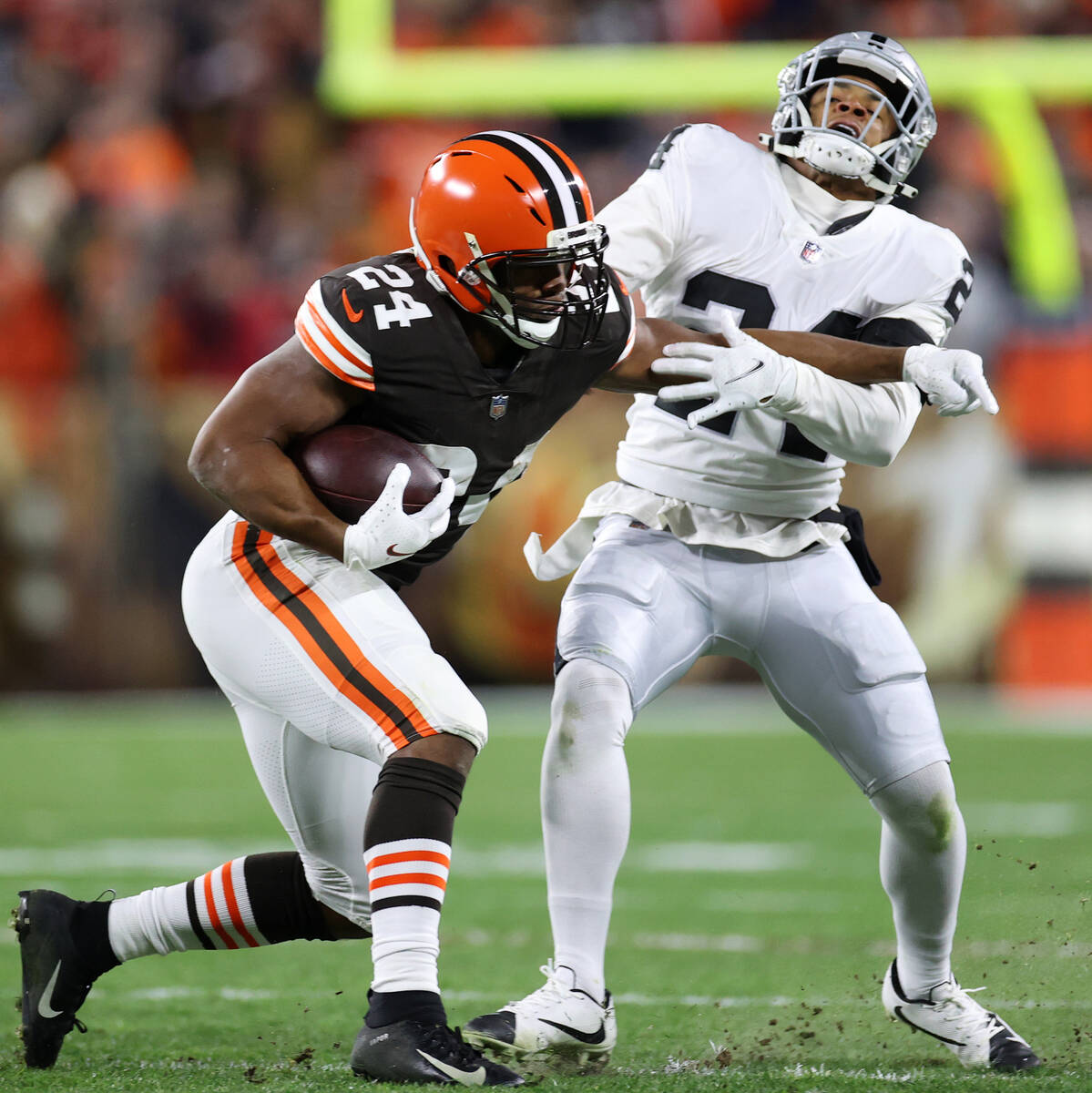 Cleveland Browns running back Nick Chubb (24) stiff arms Raiders safety Johnathan Abram (24) wh ...
