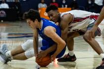 Bishop GormanÕs Ryan Abelman (0) and Liberty High Aaron Price Jr. (15) fight for the loose ...