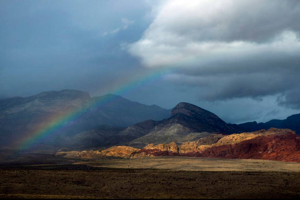 A rainbow appears above the valley floor at the Red Rock Canyon National Conservation Area as r ...