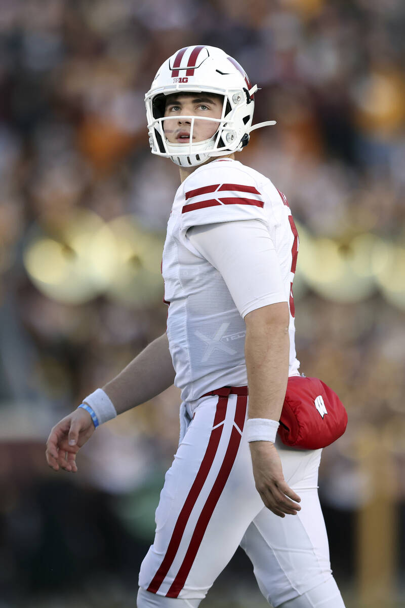 Wisconsin quarterback Graham Mertz (5) walks off the field during the first half of an NCAA col ...