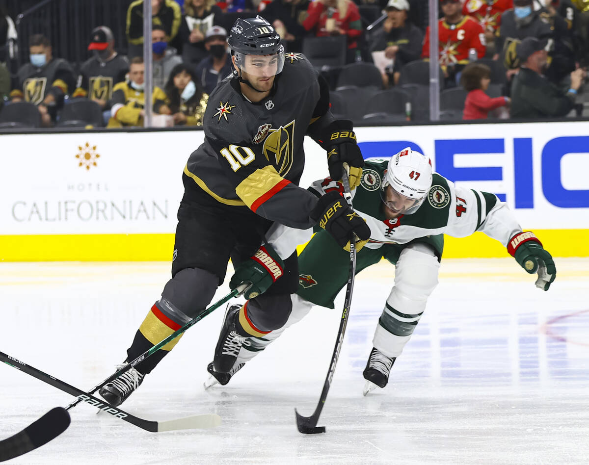 Golden Knights center Nicolas Roy (10) lines up a shot under pressure from Minnesota Wild defen ...