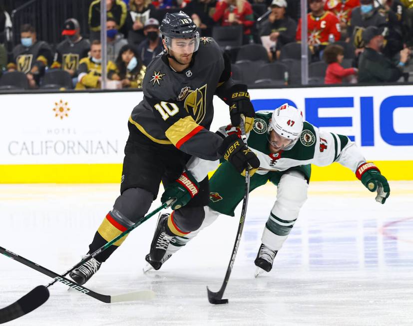 Golden Knights center Nicolas Roy (10) lines up a shot under pressure from Minnesota Wild defen ...