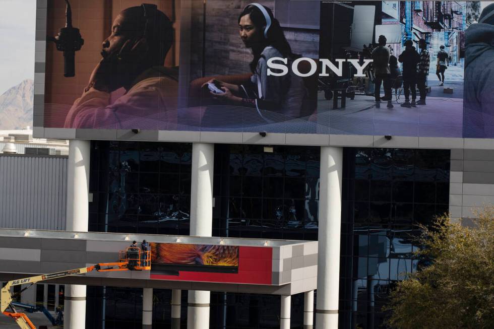 Workers install large size commercial billboard ad of SONY on the Las Vegas Convention Center i ...