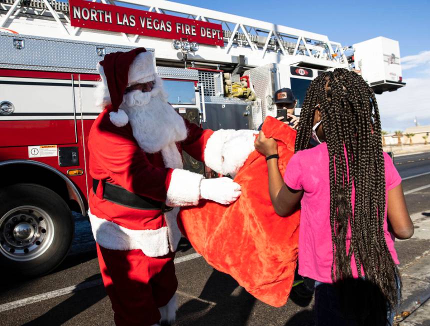 Chanel Pardue receives gifts from Santa at her residence on Friday, Dec. 24, 2021, in North Las ...