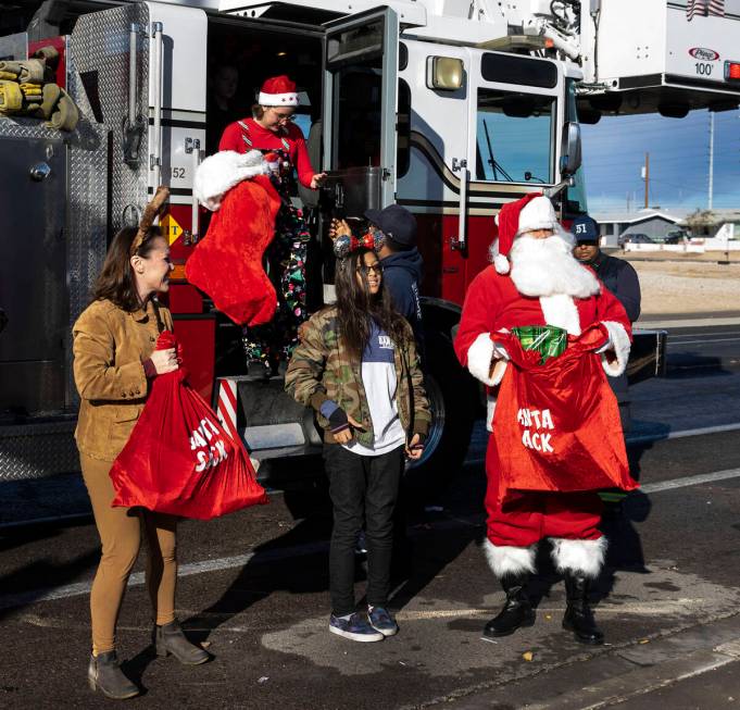 The North Las Vegas Fire Department deliver toys to Holland and Pardue family residence as part ...