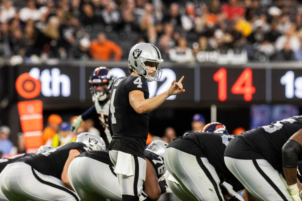 Raiders quarterback Derek Carr (4) audibles at the line in the second half of an NFL football g ...