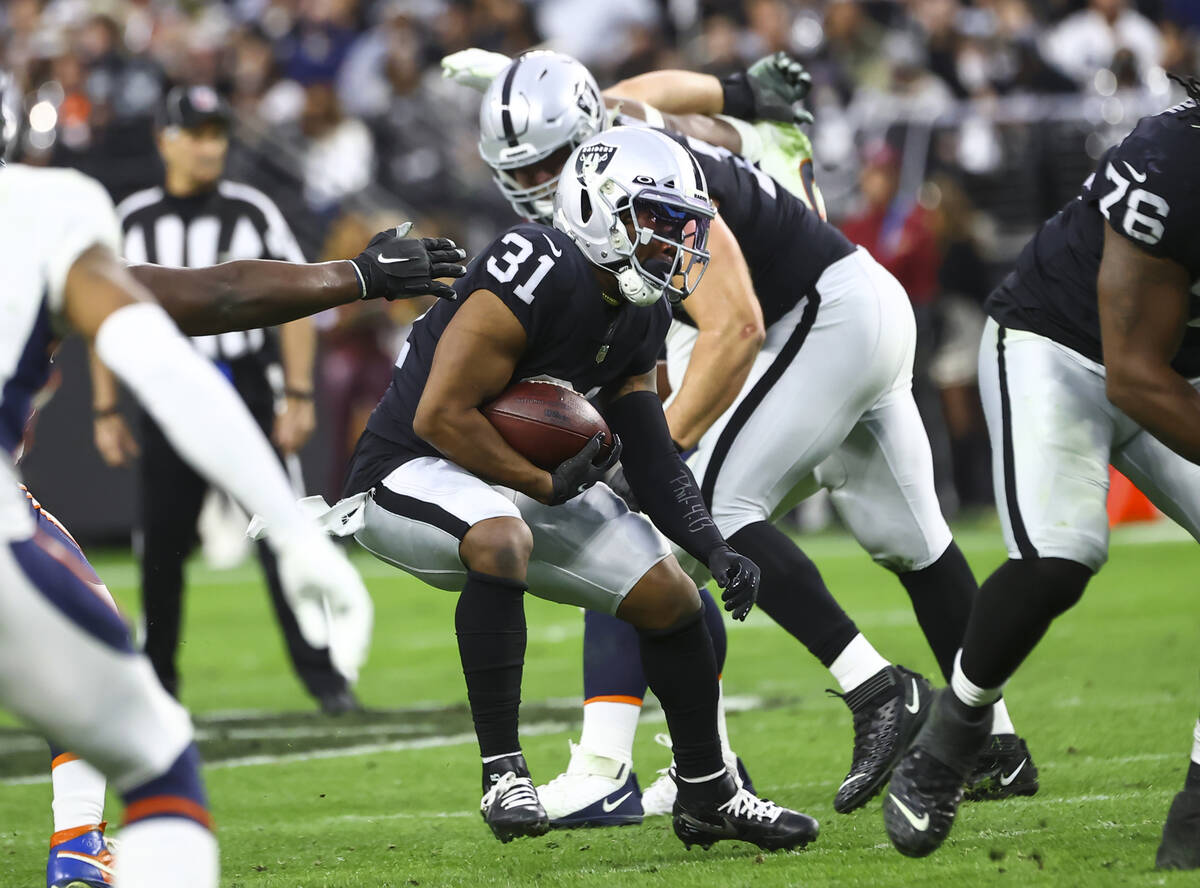 Raiders running back Peyton Barber (31) runs the ball against the Denver Broncos during the sec ...