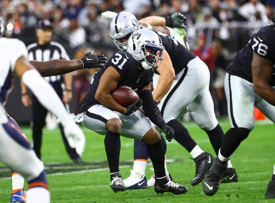 Raiders running back Peyton Barber (31) runs the ball against the Denver Broncos during the sec ...