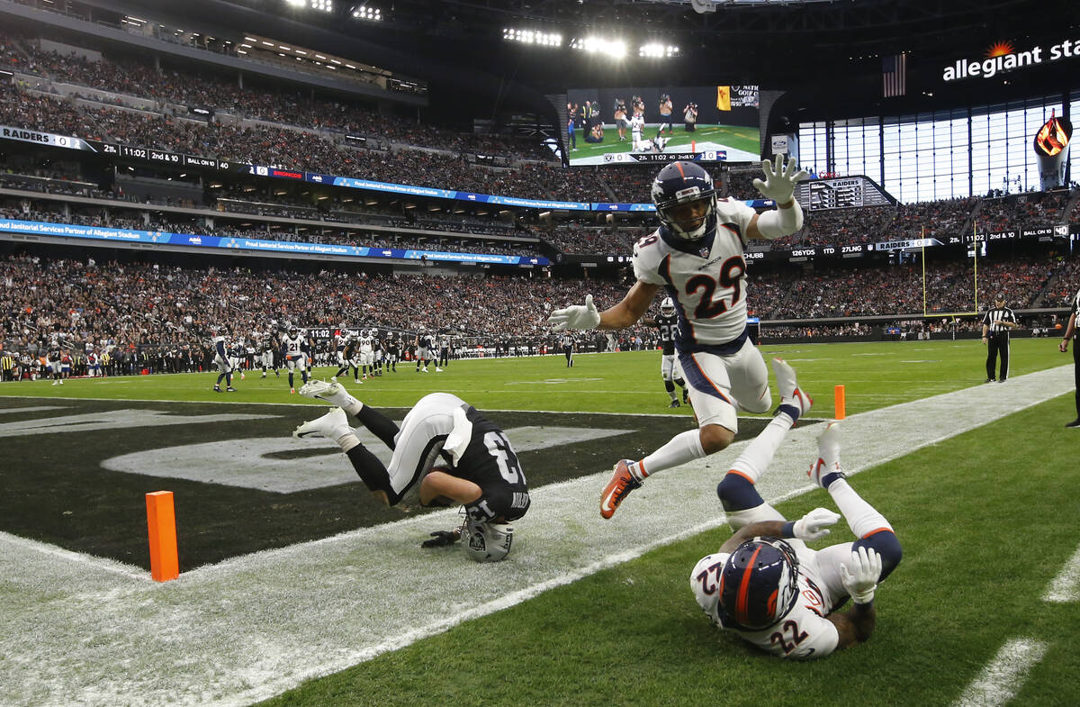 Raiders wide receiver Hunter Renfrow (13) scores a touchdown against Denver Broncos safety Kare ...