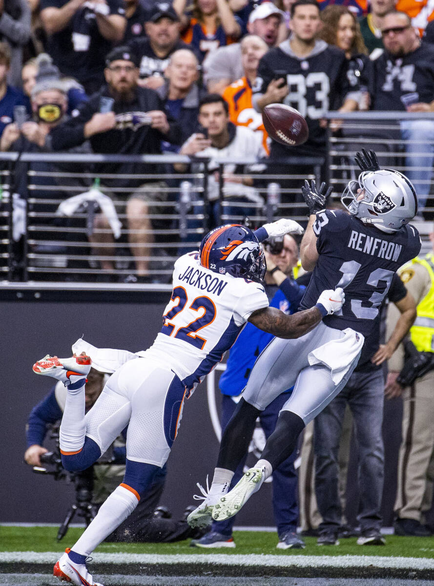 Raiders wide receiver Hunter Renfrow (13) extends for a touchdown catch as Denver Broncos safet ...