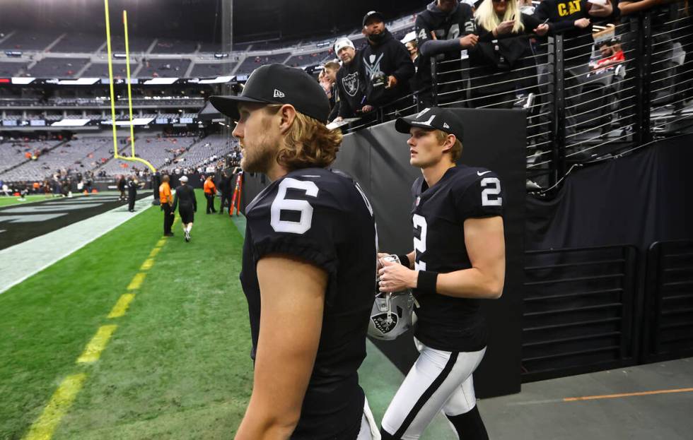 Raiders punter A.J. Cole (6) and kicker Daniel Carlson (2) walk onto the field before an NFL fo ...