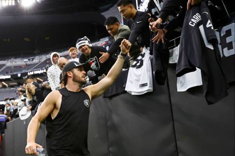 Raiders quarterback Derek Carr (4) greets fans before an NFL football game against the Denver B ...