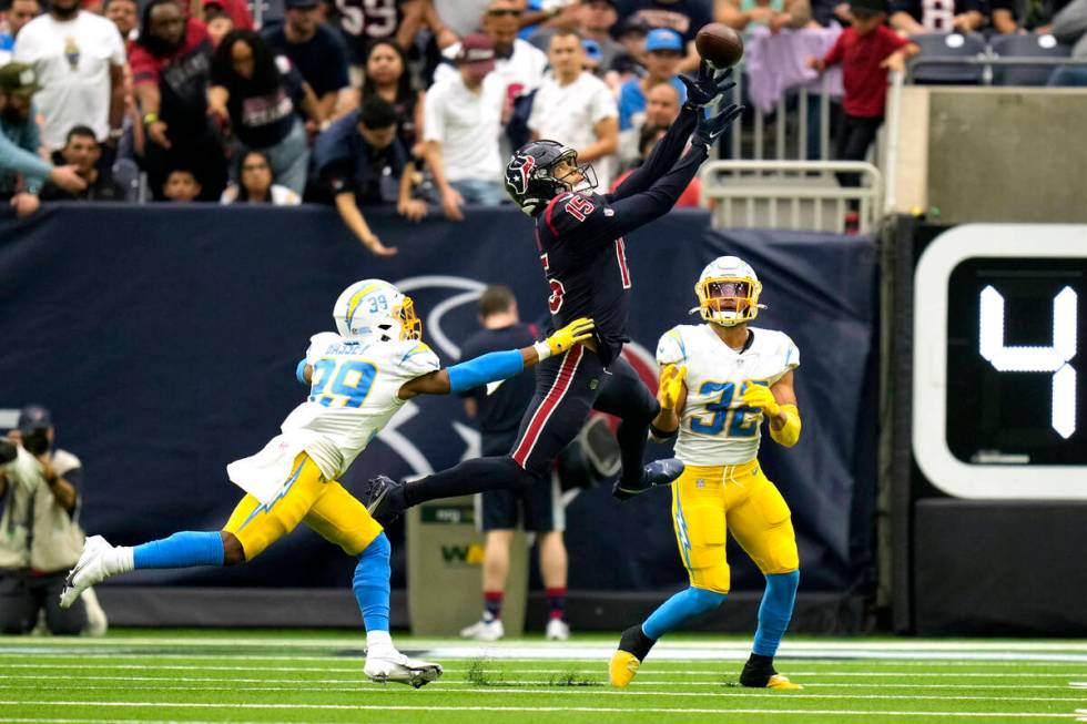 Houston Texans wide receiver Chris Moore (15) catches a pass as Los Angeles Chargers' Essang Ba ...