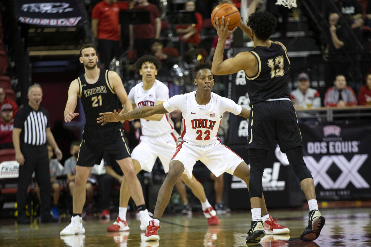 UNLV Rebels guard Josh Baker (22) defends against Whittier College Poets guard Kunal Bagga (13) ...