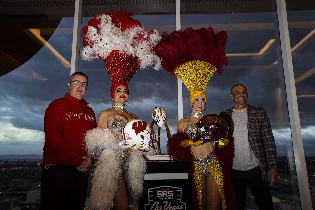 Wisconsin coach Paul Chryst, left, and Arizona State coach Herm Edwards, right, pose with showg ...