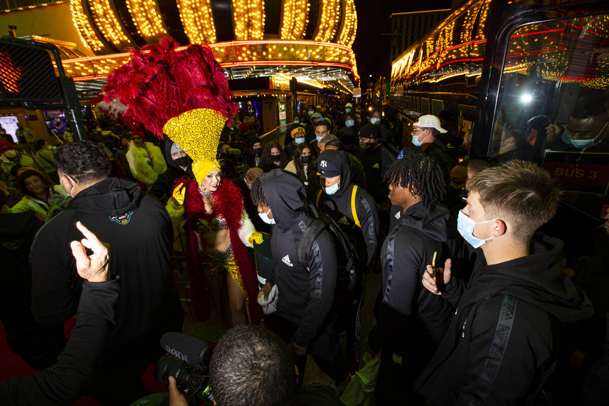 Showgirl Jennifer Autry welcomes Arizona State players as they arrive for a welcome reception a ...