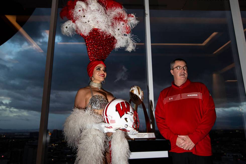 Wisconsin coach Paul Chryst, right, poses with showgirl Porsha Revesz during a media event at C ...