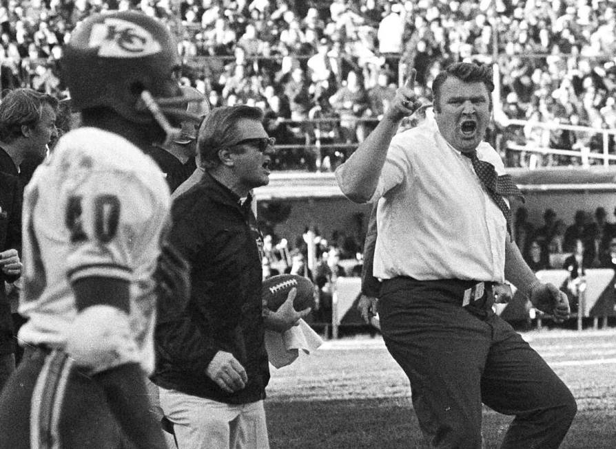Oakland Raiders coach John Madden, right, does a sort of jig as he waves his finger and shouts ...