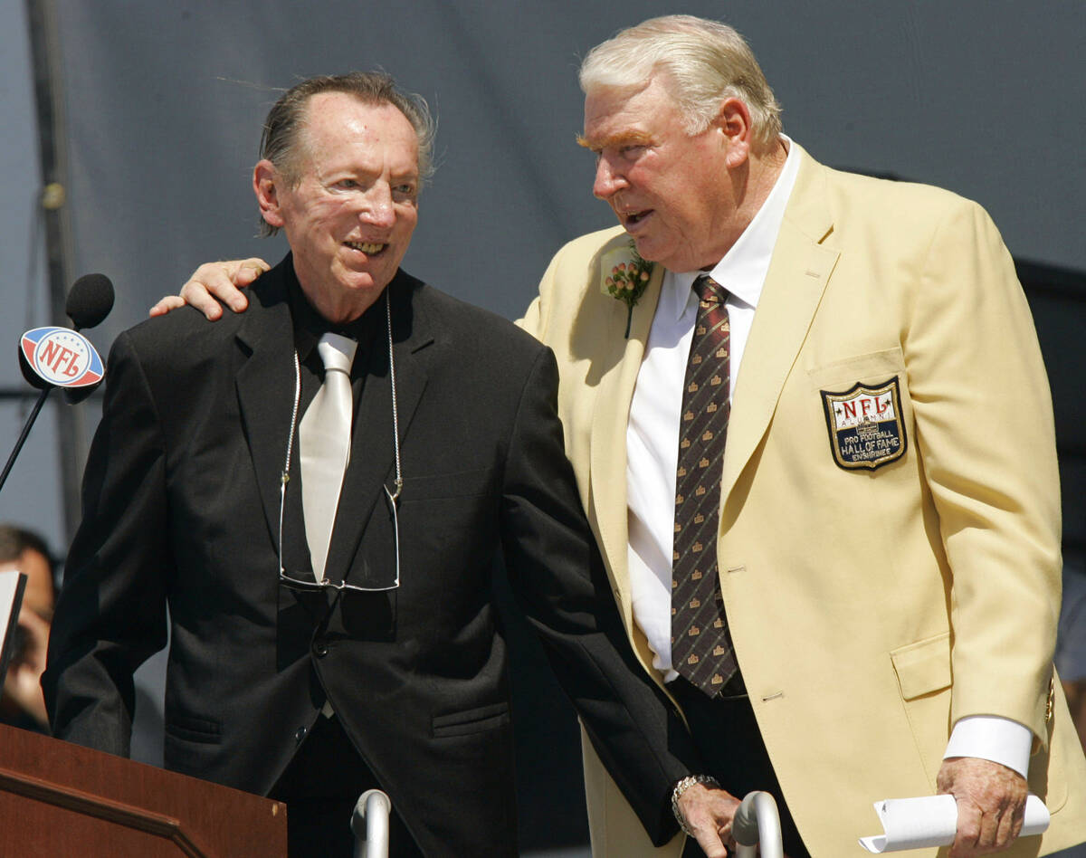 Former Oakland Raiders coach John Madden, right, puts his arm around Raiders owner Al Davis aft ...