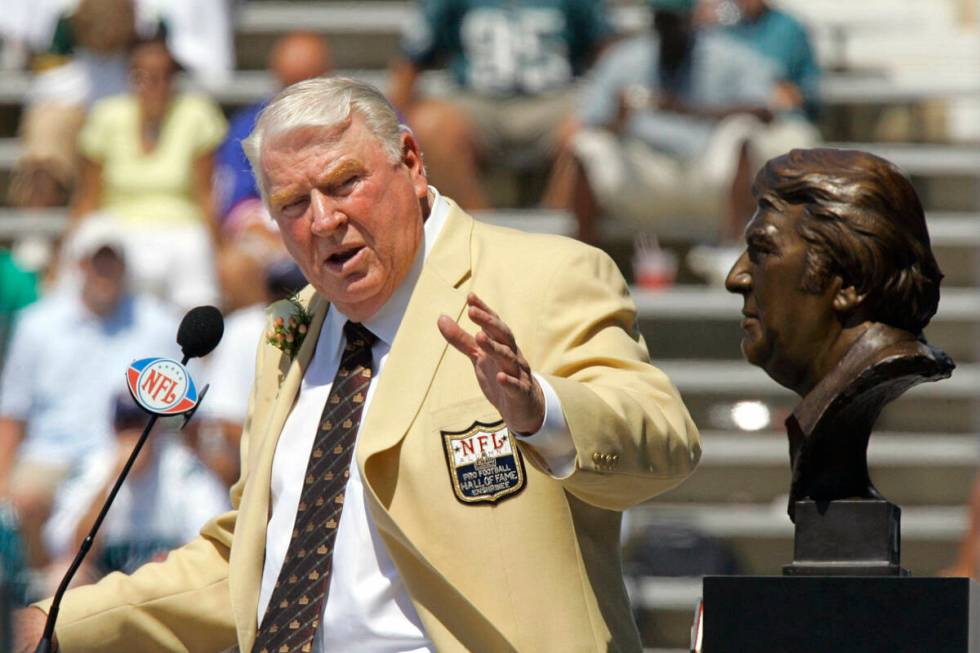 Former Oakland Raiders coach John Madden gestures toward his bust during his enshrinement into ...
