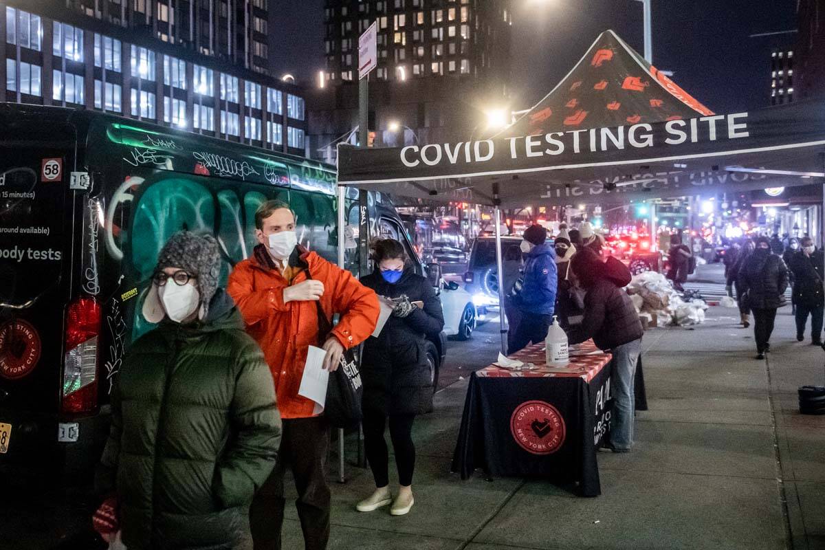 People wait on line to get tested for COVID-19 on Dec. 21, 2021, in New York. More than a year ...