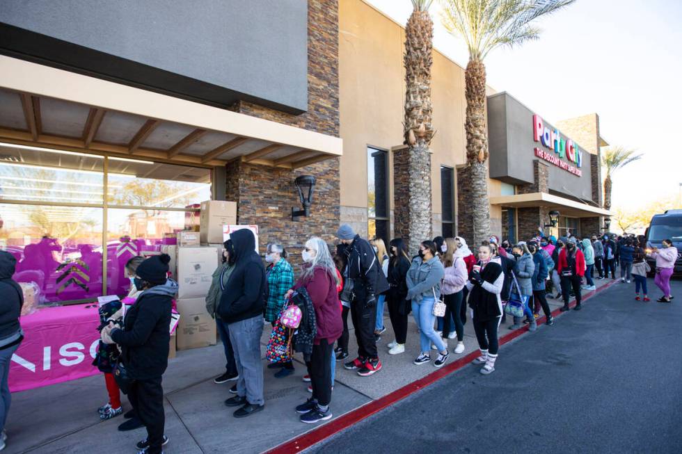 Customers line up to enter Daiso, a popular Japanese discount store, during the grand opening o ...