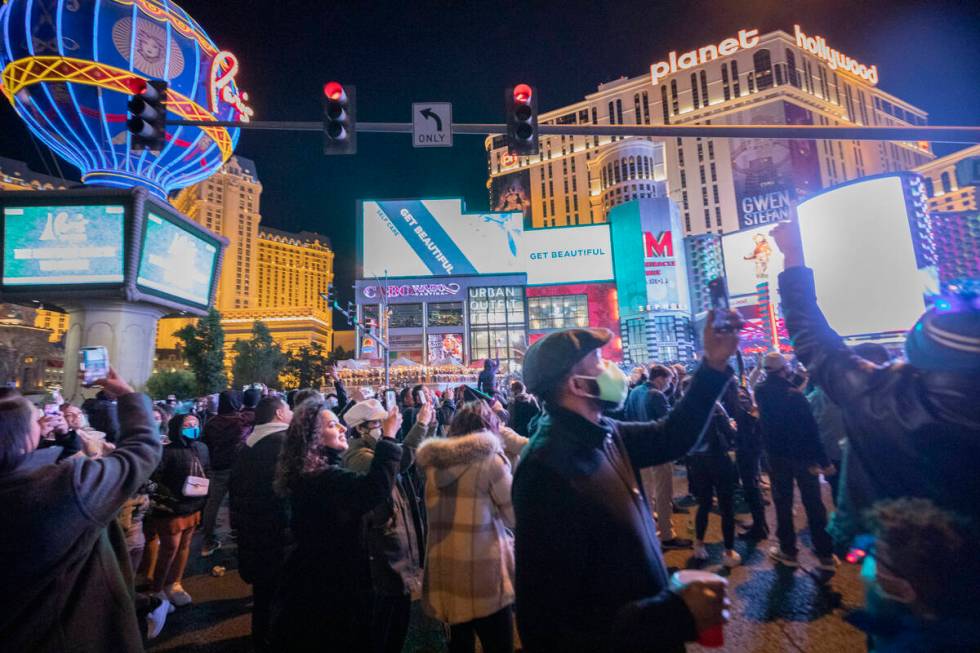 Individuals gather to celebrate New Year's Eve on the Las Vegas Strip, Thursday, Dec. 31, 2020. ...