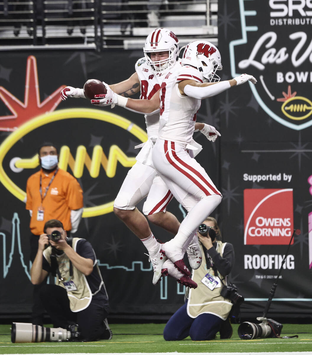 Wisconsin Badgers tight end Jake Ferguson (84) celebrates his touchdown with wide receiver Chim ...