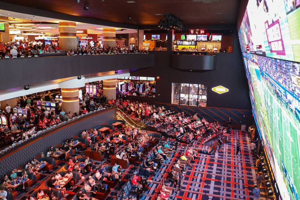 Guests watch the screens for the first week of the NFL season at the Sportsbook at Circa in Las ...