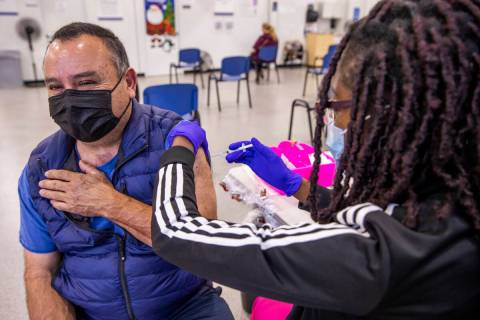 Jose Grajeda, left, is given a shot by Adwoa Fosu in the COVID-19 vaccination clinic at the Sou ...