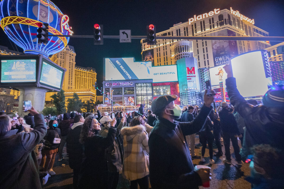 People gather to celebrate New Year's Eve on the Las Vegas Strip on Dec. 31, 2020. (Elizabeth P ...