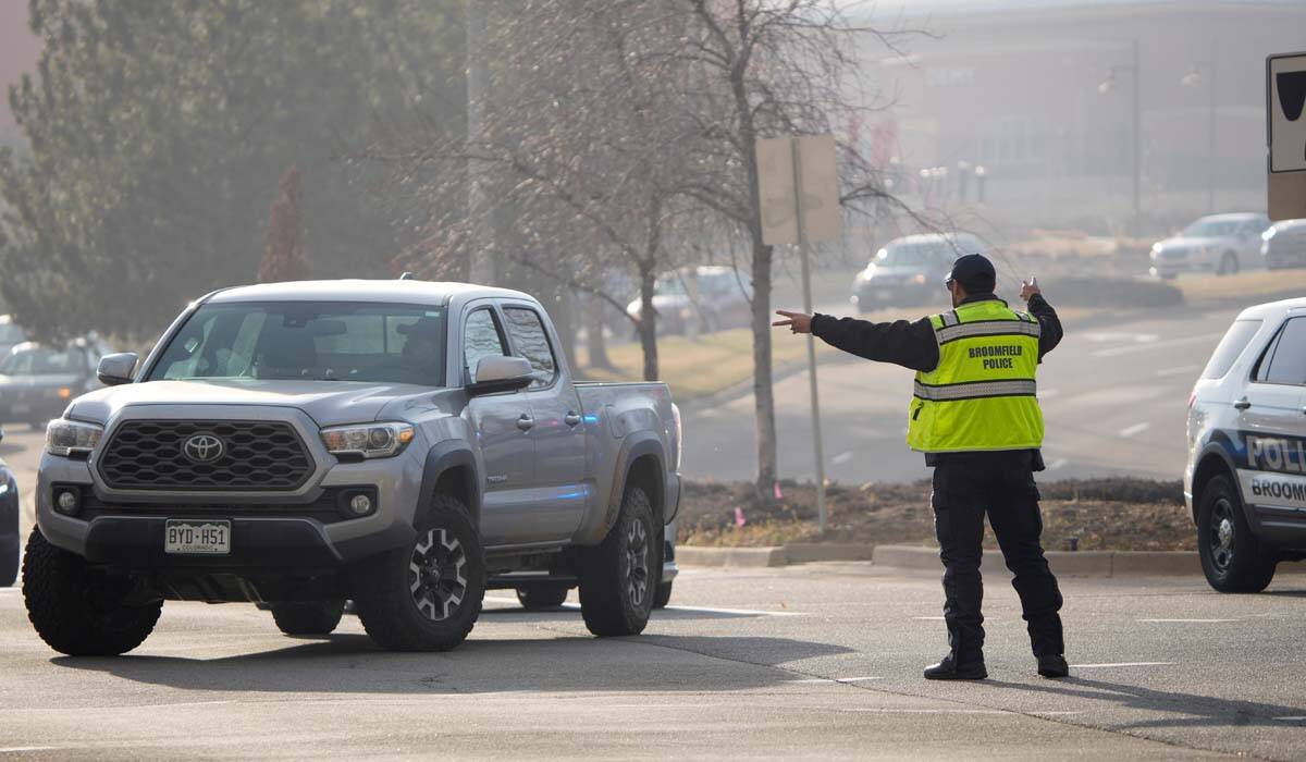 A Brookfield Police officer directs motorists along Flatiron Crossing Drive by the Flatiron Cro ...