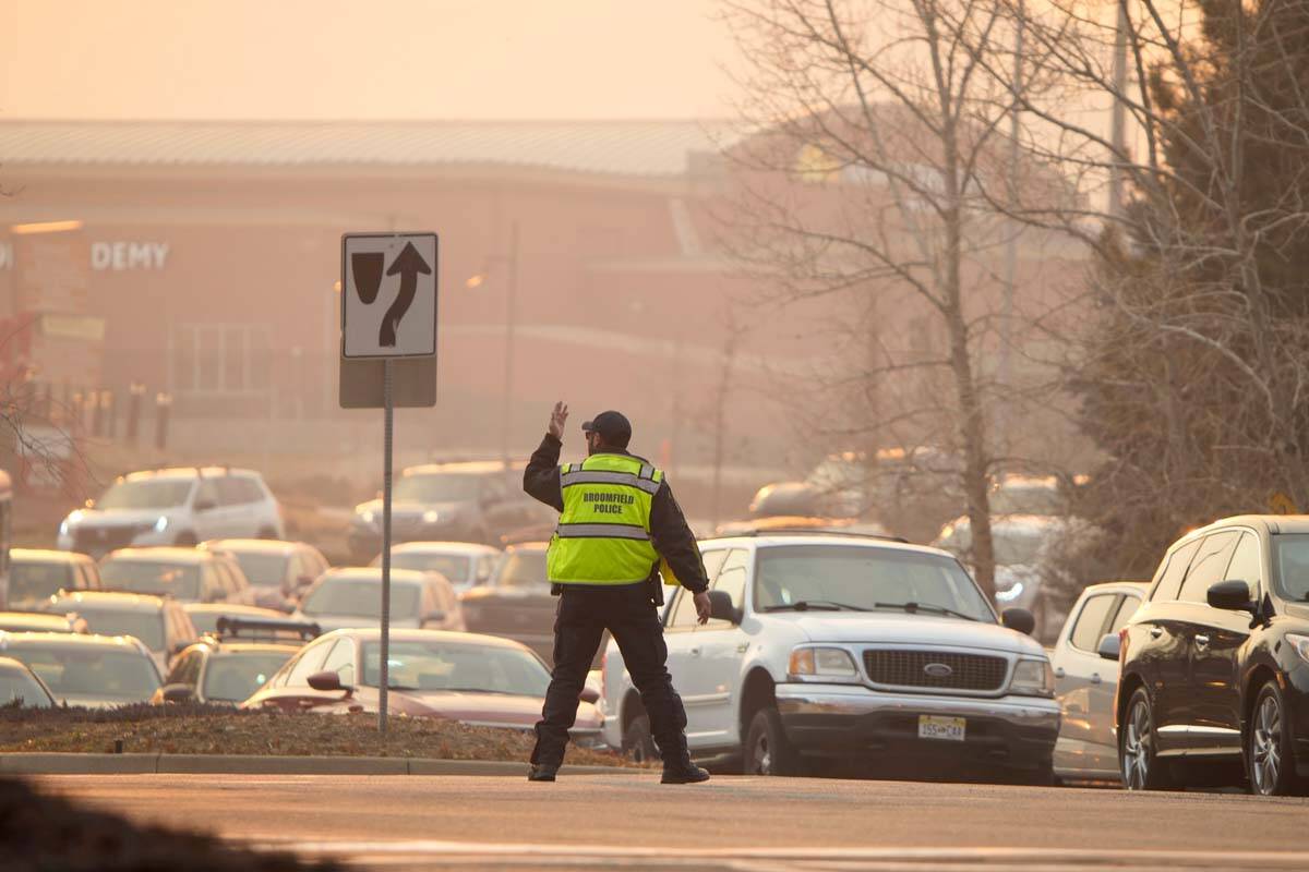 Broomfield Police direct motorists during an evacuation as a wildfire burns near a shopping cen ...