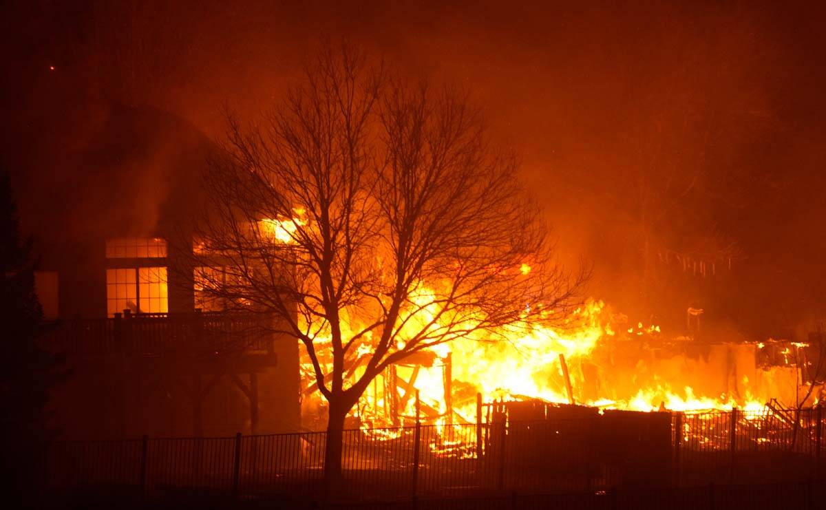 Homes burn as wildfires rip through a development Thursday, Dec. 30, 2021, in Superior, Colo. ( ...