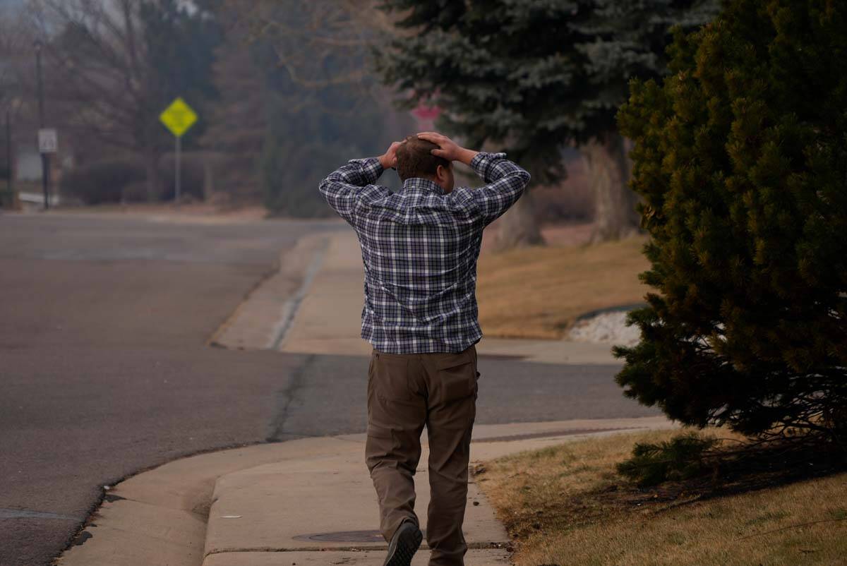 A resident asses the damage to homes in his neighborhood, Dec. 31, 2021, in Superior, Colo. An ...