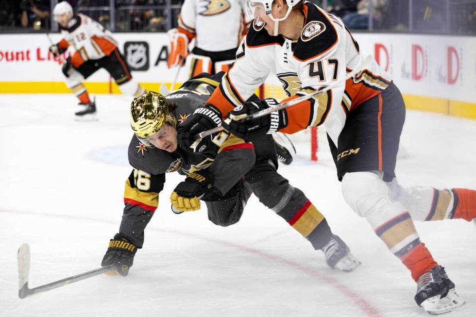 Golden Knights center Mattias Janmark (26) dives toward the puck while Ducks defenseman Hampus ...