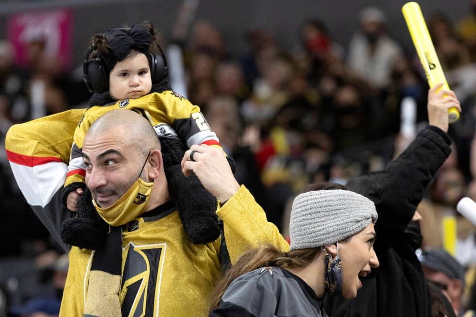 Golden Knights fans celebrate after Golden Knights goaltender Laurent Brossoit (39) saved a sho ...