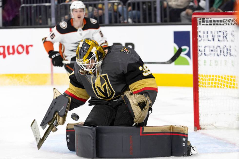 Golden Knights goaltender Laurent Brossoit (39) saves a shot on goal while Ducks defenseman Sim ...