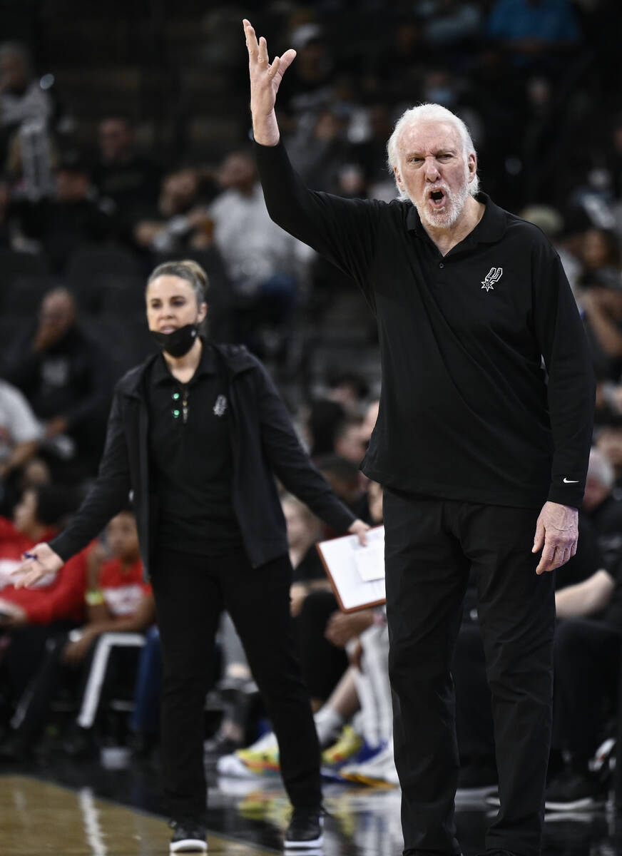 San Antonio Spurs head coach Gregg Popovich, right, and assistant coach Becky Hammon, left, com ...