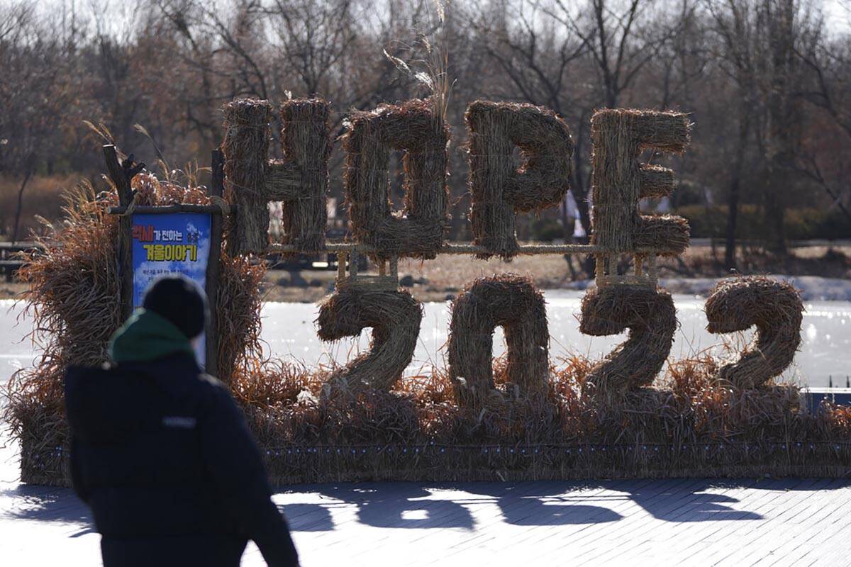 A man looks at the decorations for the coming 2022 Year on New Year's Eve in Seoul, South Korea ...