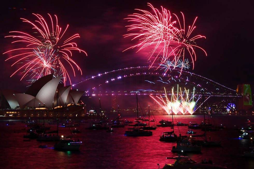 Fireworks explode over the Sydney Opera House and Harbour Bridge as New Year's Eve celebrations ...