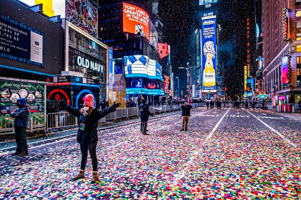Jaclyn Bernstein of New York stands in confetti, among the few to observe the Times Square New ...