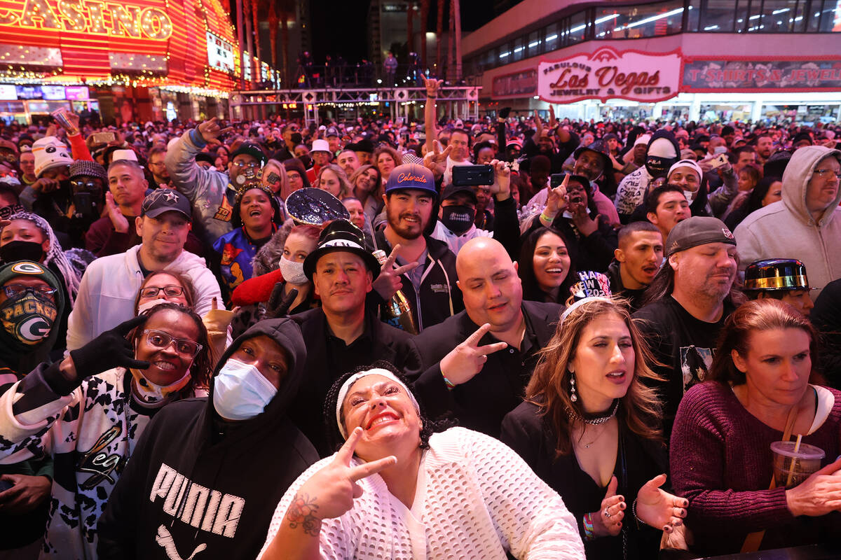 Fans react during a Bobby Brown performance on New Year’s Eve at the Fremont Street Expe ...