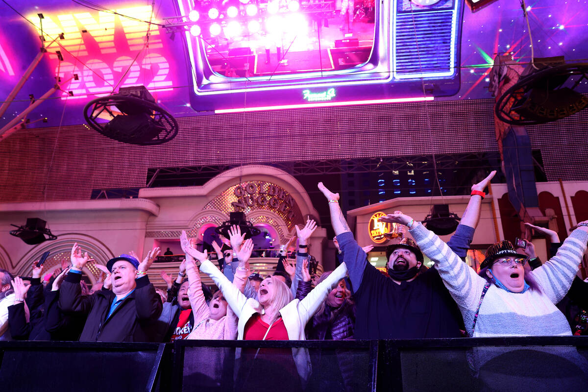 Revelers dance to the Village People on New Year's Eve at the Fremont Street Experience in down ...