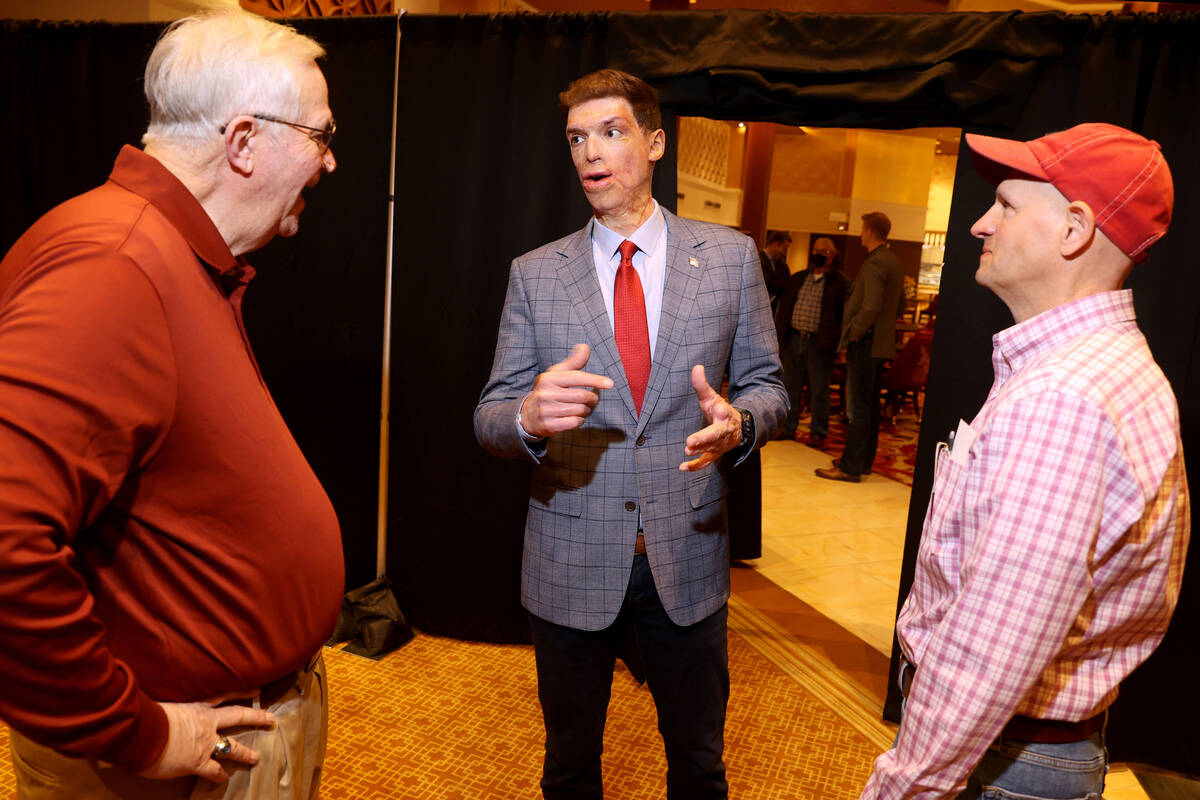 Sam Brown of Reno, a Republican candidate for U.S. Senate, visits with Jim Beckham, left, and M ...